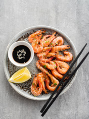 Shrimp glazed in soy sauce with green onion and lemon.