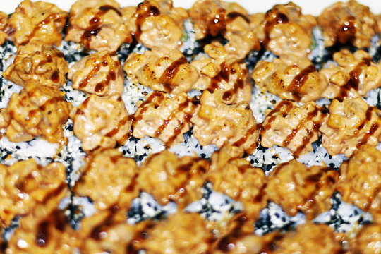Panorama banner of traditional Japanese dishes with uramaki sushi, gomoku yakisoba, tempura shrimp and fried noodles with shellfish and squid