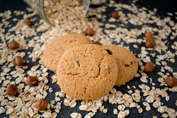 oatmeal cookies with hazelnuts on black table