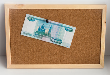 Russian money pinned to the cork Board as payment