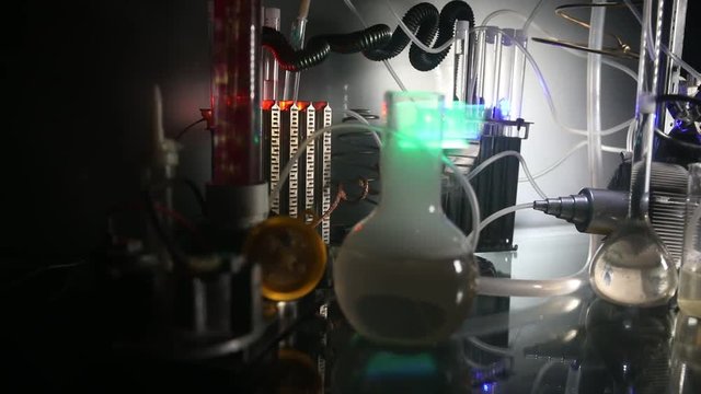 Pharmacy and chemistry theme. Test glass flask with solution in research laboratory. Science and medical background. Laboratory test tubes on dark toned background , science research equipment concept