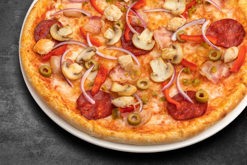 pizza with sausage and mushrooms. the dark background of the table. cafe or restaurant menu and...