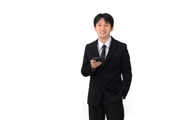 Handsome Asian businessman using mobile phone on white background