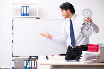 Young handsome financial speciaist in front of white board 