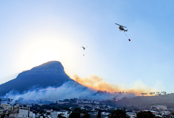 Fire helicopters  fighting a growing wildfire on the 27th of January 2019 at Lion's Head in Cape Town, South Africa