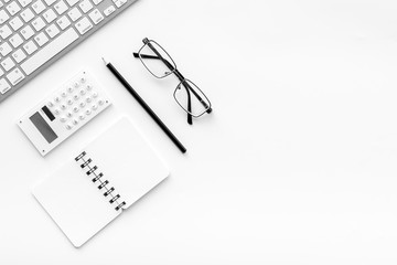 Naklejka premium Office desk in order. Geometry. Computer keyboard and office supplies, glasses on white background top view copy space