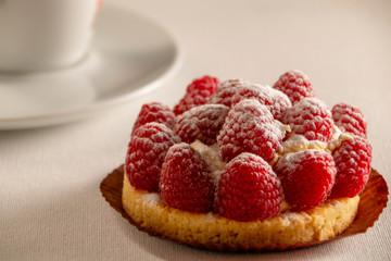 beautiful raspberry cake on a white background, side view