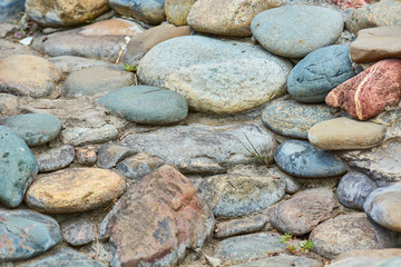 Lined wall of round stones.