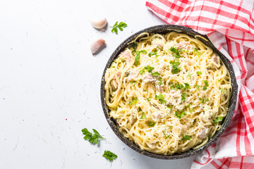 Pasta carbonara with bacon and cream sauce on white. 