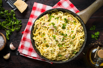 Pasta carbonara with bacon and cream sauce top view. 