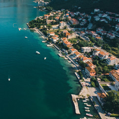 aerial view of seaside with boats and building roofs