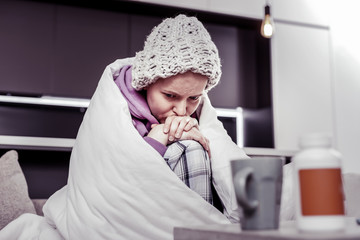Depressed female person being deep in her thoughts