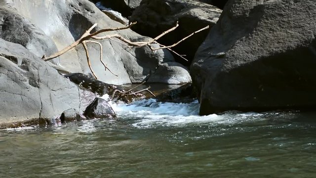 water flow across the stone in a mountain creek.