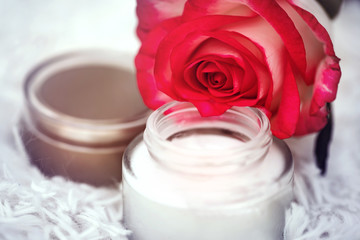 Fototapeta na wymiar open round jar with cream and rose