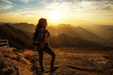 Hiker meets the sunset on the Moro rock in Sequoia national park, California, USA.