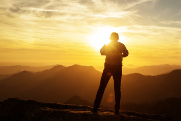 Hiker meets the sunset on the Moro rock in Sequoia national park, California, USA.