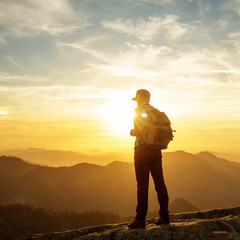 Hiker meets the sunset on the Moro rock in Sequoia national park, California, USA.