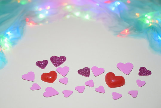 Symbolic image of Valentine's day candles, hearts, pink.