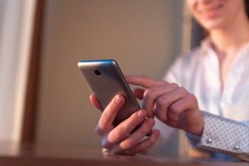 Using a mobile phone for online communication, working, shopping and chatting with friends. Phone and Internet addiction. Free Wi-fi