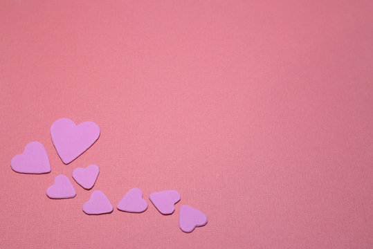 Symbolic image of Valentine's day candles, hearts, pink.