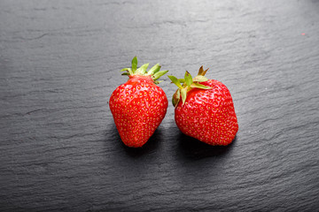 ripe strawberry on black background