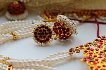 Indian decorations for dancing: earrings, gold scarf and decoration on the neck and on the head. Indian classical dance style bharatanatiam. White background.