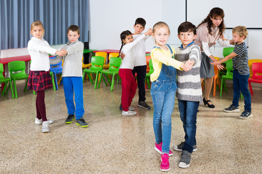 Kids and teacher dancing