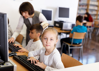 Fototapeta premium Preteen girl studying in computer class