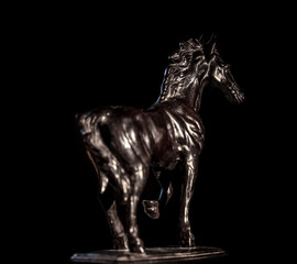 Beautiful statue of a black horse on a black background