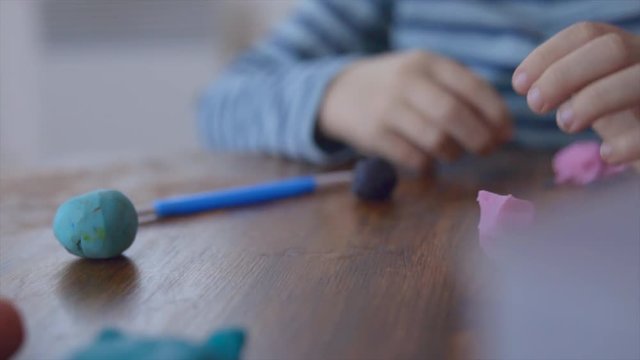 Close up hands sculpts plasticine shape