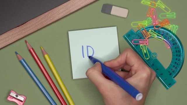 School concept. Womans hand writing IDEA on notepad