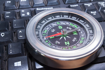 compass over a black computer keyboard