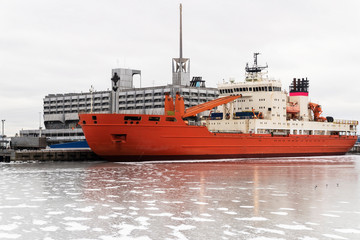 Fototapeta premium Large cargo ship in the port. Winter parking of the ship on the pier.