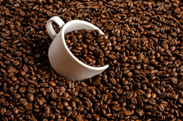 coffee beans background with white cup, copy space