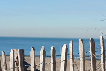 Wooden fence and sea at the background.
