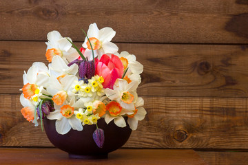 bouquet of spring flowers on wooden background