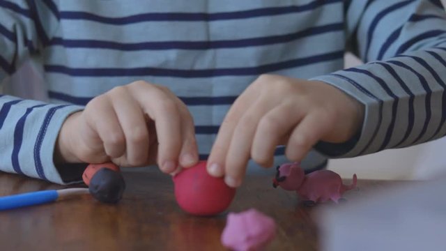Close up hands sculpts plasticine shape