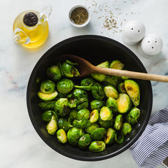 Brussels sprouts fried in a non-stick pan. spices and olive oil. cooking healthy winter food