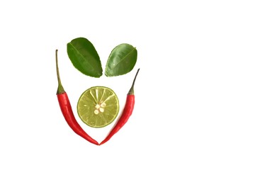 Red hot tropical chilli with a half fresh lemon and kaffir lime leaves on white isolated background 