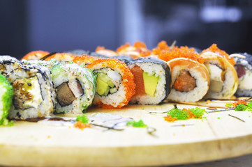Sushi set: sushi roll with salmon and sushi roll with smoked eel, selective focus.