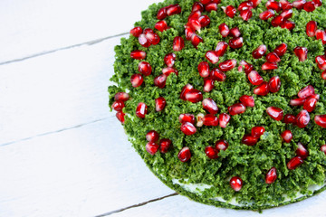 Cake "green moss" with spinach decorated with pomegranate seeds