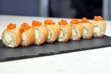 Philadelphia roll sushi with salmon, smoked eel, cucumber, avocado, cream cheese, red caviar. Sushi menu. Japanese food.