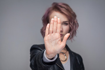 Stop. Portrait of serious beautiful girl with short hairstyle in casual style black leather jacket...