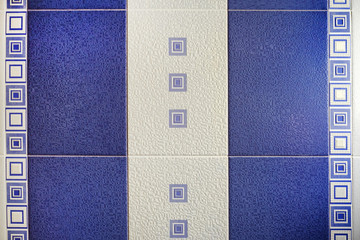 The design of the wall is made of tile for the bathroom. Natural texture. Colored stone structure