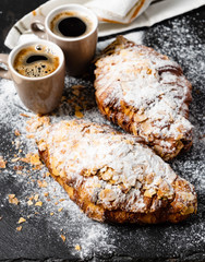 Croissants with almonds on the black background