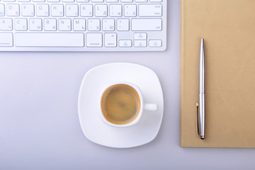 office table with notebook, computer keyboard,, cup of coffee, tablet pc. copy space.