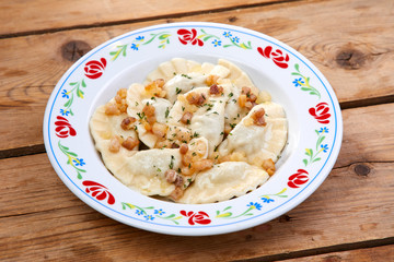 dumplings with potato on the wooden background