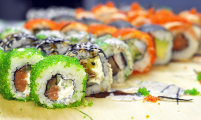 Sushi set: sushi roll with salmon and sushi roll with smoked eel, selective focus.