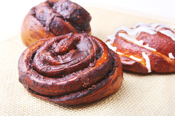 Freshly baked homemade sweet rolls with cinnamon on white background. Healthy Food Snack Concept. Copy space.
