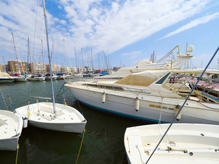 Fototapeta premium Luxury yacht marina. Port in Mediterranean sea. Sailing boats with a deflated sails near the sea pier.